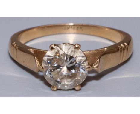 18ct yellow gold diamond solitaire ring, the single brilliant cut diamond in claw setting on tapered shoulders and grooved sh