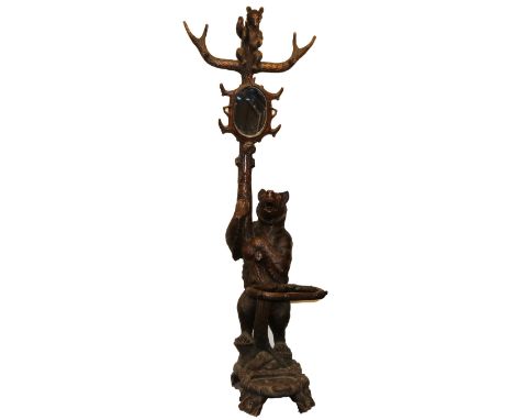 C19th carved Bear Black Forest hall stand, the parent Bear supporting a trunk with oval mirror, naturalistic coat hooks and s