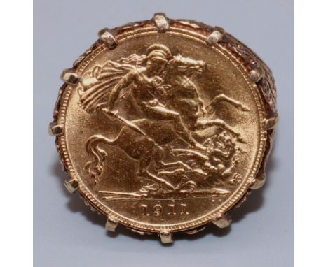 Edw.VII 1911 half sovereign, in 9ct yellow gold ring setting, with pierced scroll shoulders, stamped 9ct, size J, 10.5g 
