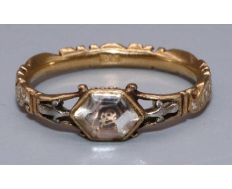 Mid C18th yellow metal and white enamel Memento Mori mourning ring set with hexagonal rock crystal above skull motif, dedicat