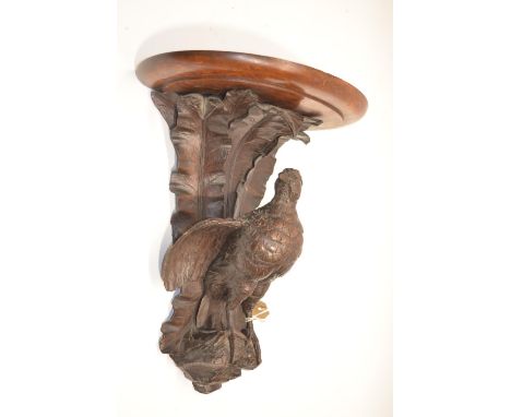 Black Forest style oak wall bracket, D shaped top on game bird support with leafage cresting, top, stamped R. Tudsbery, Artis