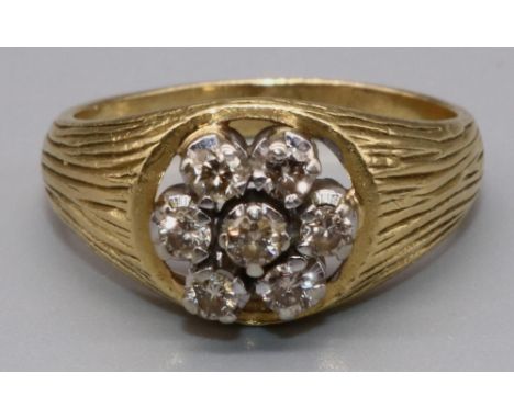18ct yellow gold diamond cluster ring, the seven brilliant cut diamonds on signet style textured band, stamped 18ct, size O1/