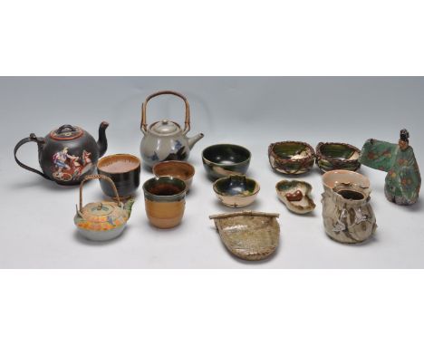 A collection of Chinese oriental terracotta and pottery teapots to include celadon glazed teapot with rattan handles, stork h
