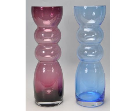 Two retro vintage late 20th century Dartington glass vases having ribbed body under a flared rim. One vase has an amethyst co