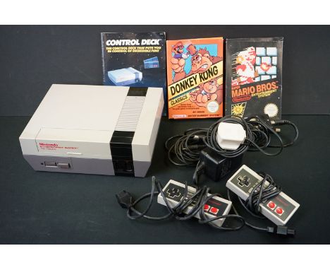 Retro Gaming - Nintendo NES console with 2 x controllers and 2 x boxed games to include Donkey Kong and Super Mario Bros, bot