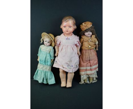 Three dolls to include a Melba (1915-1920) English doll, bisque headed, painted eyes and face, original clothing, a plastic m