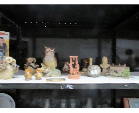 A shelf of owl figures etc