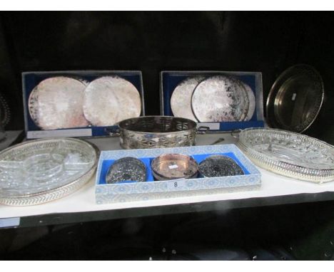 A shelf of silver plate entree' dishes, coasters etc