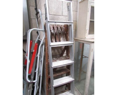 An aluminium step ladder and a wooden step ladder