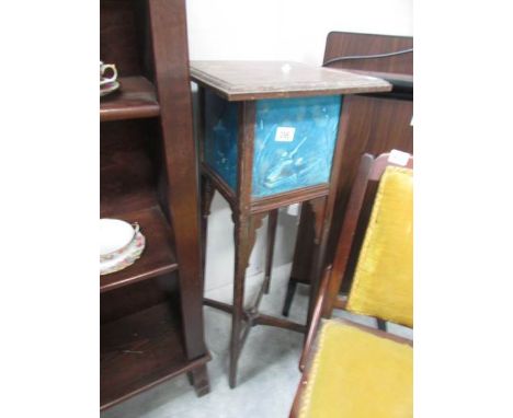 A plant stand with tile inset depicting hunting scenes