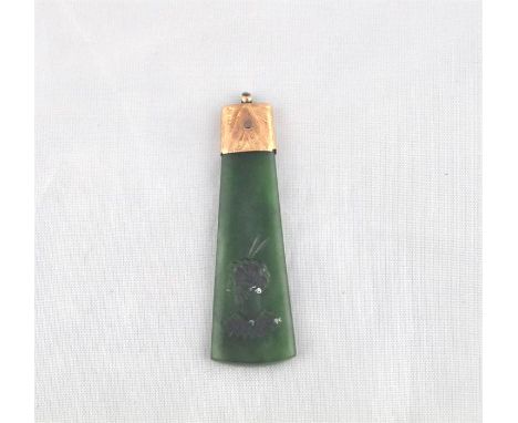 A Maori nephrite jade intaglio axe form pendant, of gently tapering form with curved base, having profile bust intaglio to on