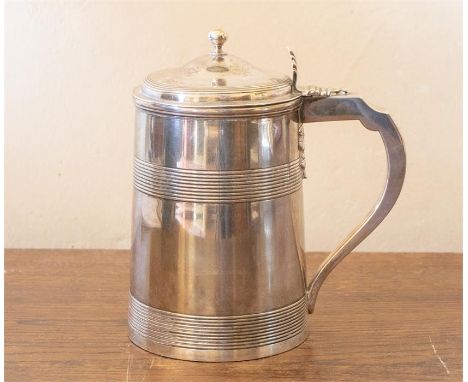 A George III silver tankard, tapering cylindrical with upper and lower reeded sections, the domed cover with ball finial and 