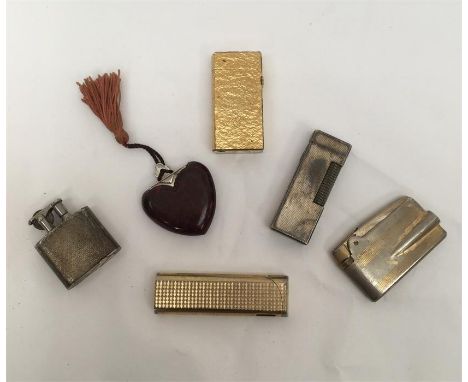 A quantity of cigarette lighters, to include; Dunhill 70 gold plated textured rollagaz table lighter, a similar silver plated