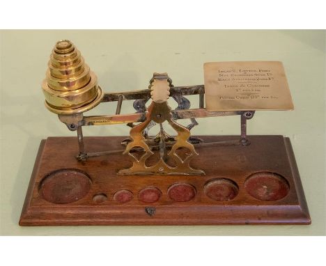 A brass set of Mordan &amp; Co postal scales, with seven round flat weights&nbsp;
