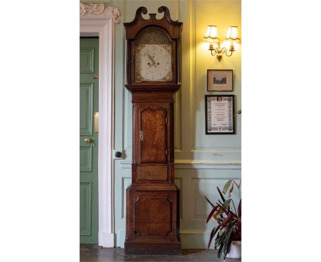 A 19th Century Bell of Uttoxeter oak and mahogany crossbanded longcase clock, swan neck pediment, arched painted dial with su