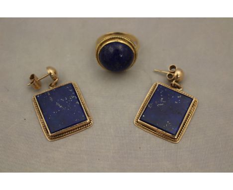 A pair of yellow metal and lapis lazuli drop earrings, having hemisphere of yellow metal suspending rectangular filigree work