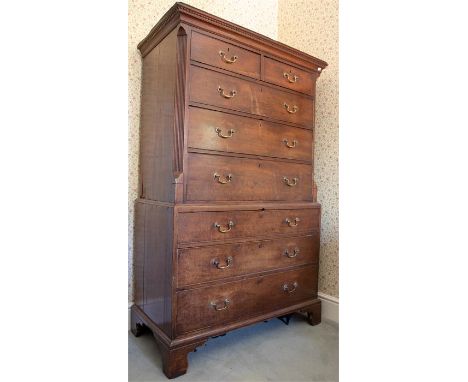 A George III mahogany chest on chest, dentil cornice, two short over three long drawers flanked by canted reeded pilasters, t