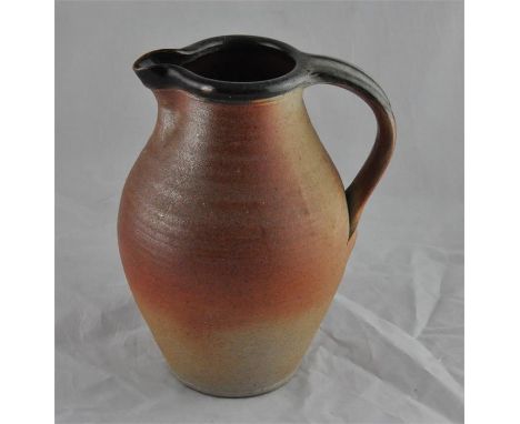 A John Leach stoneware studio pottery jug, of ovoid form with ribbed body and dripped slip green clay rim and handle, impress