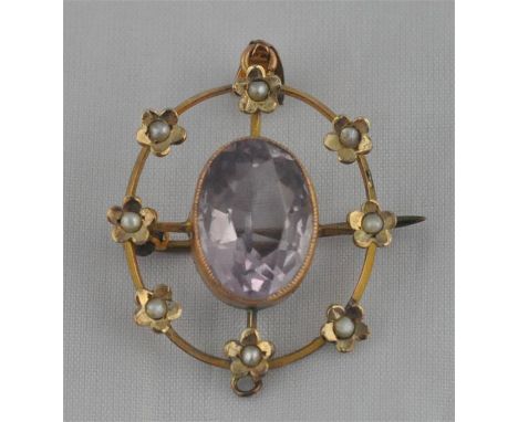 A yellow metal, amethyst and seed pearl set brooch, of oval open work form, having border with eight yellow metal flowers eac