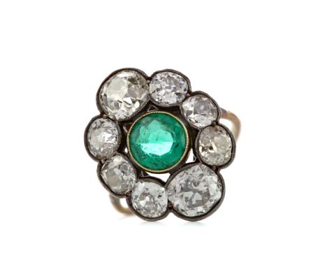 IMPRESSIVE EMERALD AND DIAMOND RING, the round emerald within a halo of Old Mine cut diamonds totalling approximately 4.50 ca