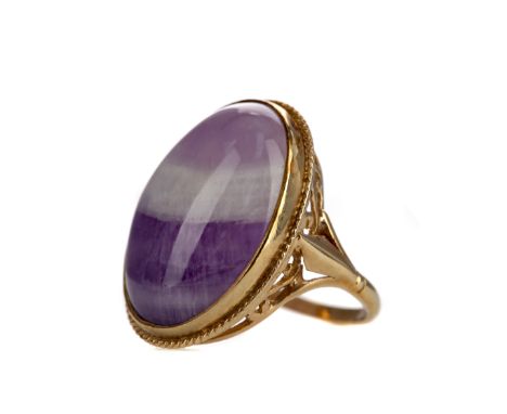 AMETHYST RING, the cabochon amethyst 23mm long, in nine carat gold, size N 1/2, 8.5g