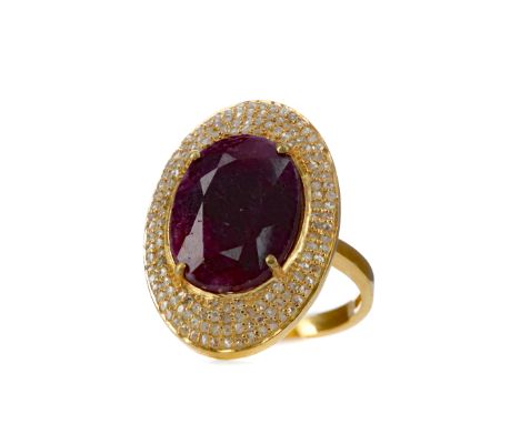RUBY AND DIAMOND RING, the oval ruby of approximately 12.00 carats within a diamond set bezel, the diamonds totalling approxi