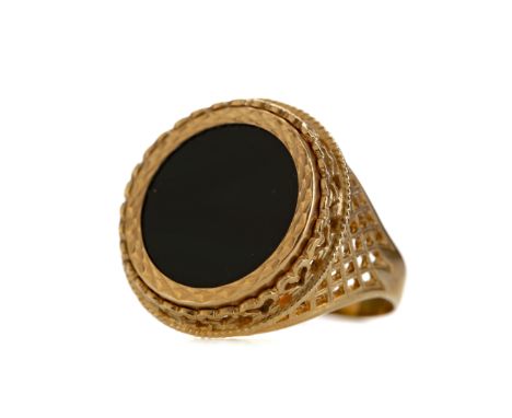 BLACK HARDSTONE RING, the round black hardstone within an openwork nine carat gold mount, size R, 5g