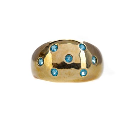 BLUE GEM SET RING, of bombe form, with countersunk blue gems, in nine carat gold, size T, 4.6g