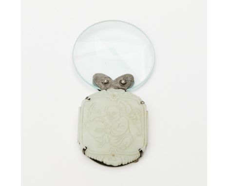 The shaped plaque carved to face showing a youthful attendant with a peach; later magnifying glass mount.(Height of jade 2 1/
