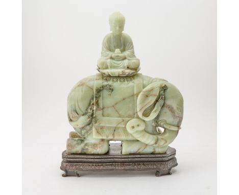 Carved to depict serene, meditative Amitabha seated atop a robust elephant adorned with harnesses and saddlecloth; with a fit
