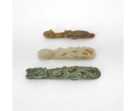 Comprising a white jade, a spinach jade dragon hook, together with a mottled jade cicada hook.(Length of largest 4 3/4 inches