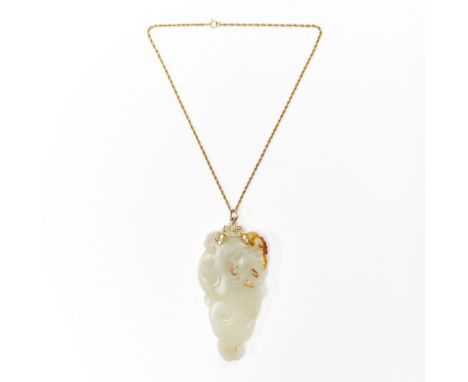 18th CenturyCarved in the form of an archaistic, writhing dragon; the stone of white and russet coloring; 14k gold string.Wid