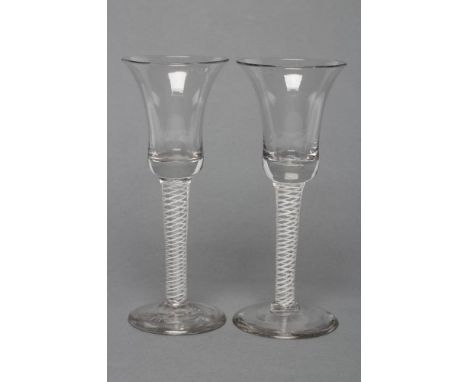 A PAIR OF WINE GLASSES, late 18th century, the bell bowls on mixed twist stems with two central air twist gauze surrounded by