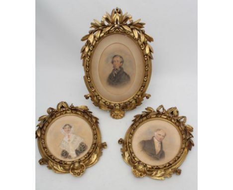 A VICTORIAN CARVED GILT WOOD OVAL PICTURE FRAME, with ribbon inner border, berried laurel surmount and scrolled acanthus to b