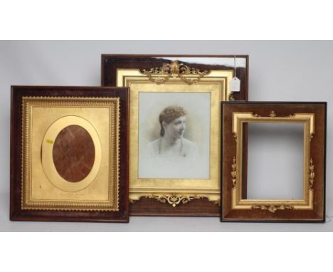 A VICTORIAN GILT GESSO PICTURE FRAME of earred oblong form with pierced scroll surmount hanging floral festoons, floral side 