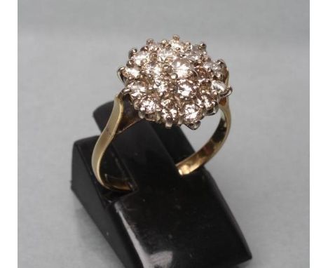 A DIAMOND CLUSTER RING, the nineteen brilliant cut stones claw set to a plain 18ct gold shank, London 1988, size L 1/2 (Est. 