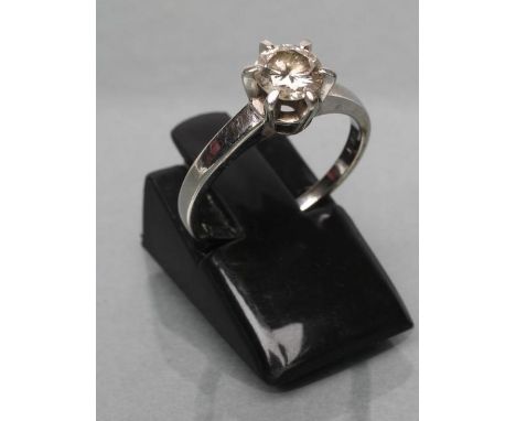 A SOLITAIRE DIAMOND RING, the round brilliant of approximately 0.4cts claw set to a plain white shank stamped 18ct, size K 1/