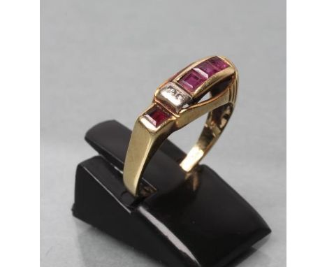 A RUBY RING, the four calibre cut stones channel set with two small diamond point spacers to a plain shank, stamped 585, size