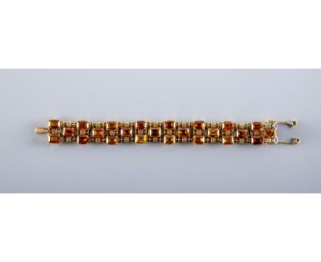 A 9CT GOLD AND CITRINE BRACELET, the twenty four step cut citrines claw set to bow shaped links, with two safety chains, spon