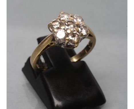 A DIAMOND CLUSTER RING, the seven old cut stones point set to a plain shank stamped 18k, size I 1/2 (Est. plus 21% premium in