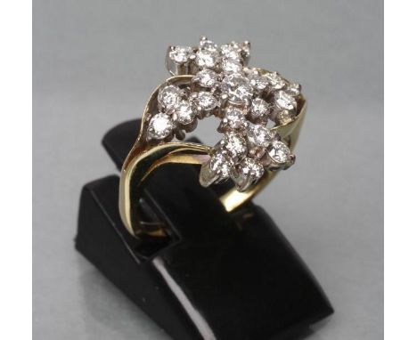 A DIAMOND COCKTAIL RING, the twenty three small round brilliants set to an asymmetric cross-over on plain unmarked shank, siz