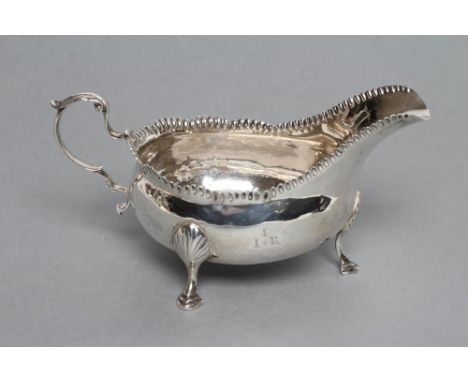 A LATE GEORGE III SAUCEBOAT, maker Langlands & Robertson, no date letter, cut duty mark c.1791, the plain oval bowl with undu