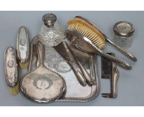 AN EDWARDIAN ELEVEN PIECE DRESSING TABLE SET, maker C.S. Green & Co. Ltd., Birmingham 1909 (one hairbrush 1910), with husk st