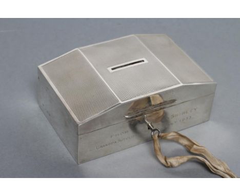 AN ART DECO MONEY BOX, maker's mark JR, Birmingham 1933, of plain oblong form, the flat domed hinged cover with engine turnin