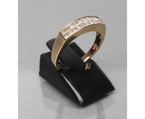 A DIAMOND HALF HOOP ETERNITY RING, the twenty princess cut stones calibre set to a plain shank stamped 14k, size N (Est. plus