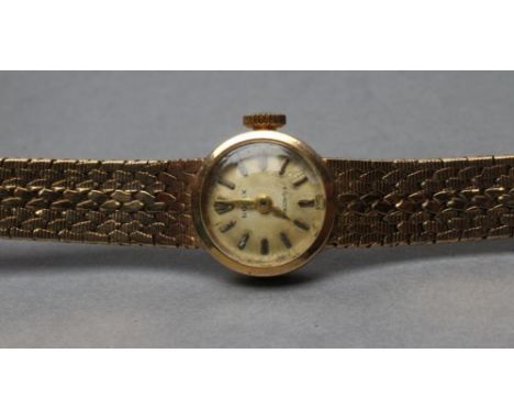 A LADY'S 9CT GOLD ROLEX WRISTWATCH, the dark champagne dial with gilt metal batons, un-numbered eighteen jewel movement in a 