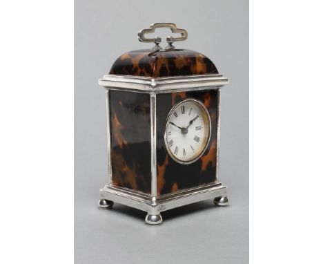 A SILVER MOUNTED TORTOISESHELL CARRIAGE CLOCK, maker Carringtons Co., London 1914, the circular white enamel dial with black 