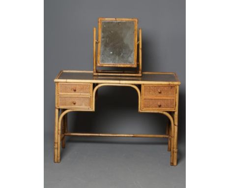 A BAMBOO AND WICKER DRESSING TABLE, c.1900, with inset glass top, the kneehole flanked by a cupboard faced as two drawers on 