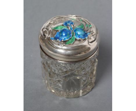 AN EDWARDIAN GLASS DRESSING TABLE JAR, maker possibly J & R Griffin, Chester 1908, the lift-off silver cover chased and ename