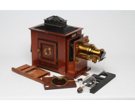 AN "OPTIMUS" MAGIC LANTERN by Perken, Son & Co. Ltd., London, in brass mounted mahogany casing, converted to electricity, con